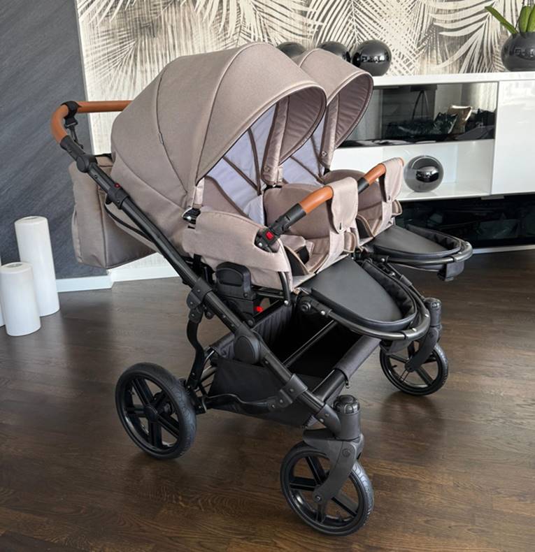Dwie spacerówki Adbor Duo Lux 3w1 ustawione obok siebie z wypinanymi barierkami