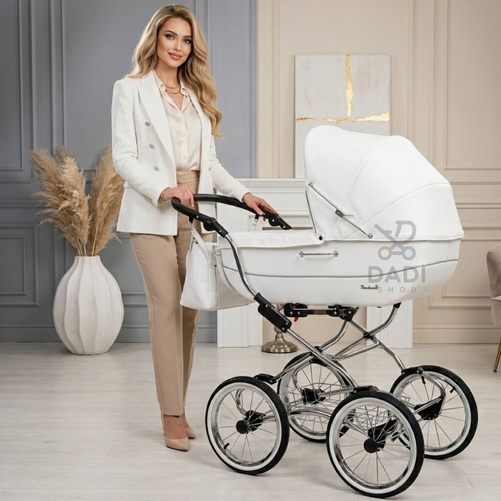 Elegancka kobieta prowadzi klasyczny biały wózek retro Baby Fashion Renee R-1 na dużych kołach.