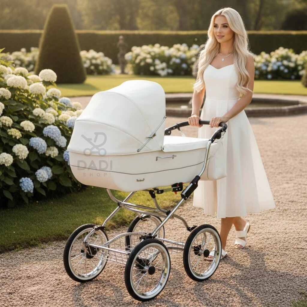 Elegancka kobieta w białej sukience prowadzi wózek Baby Fashion Renee w ogrodzie pełnym hortensji.