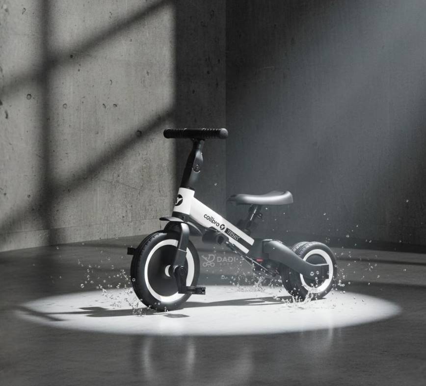 Rowerek Colibro Tremix UP 6w1 – nowoczesny design, rower wielofunkcyjny dla dzieci, efekt splash i betonowe tło.