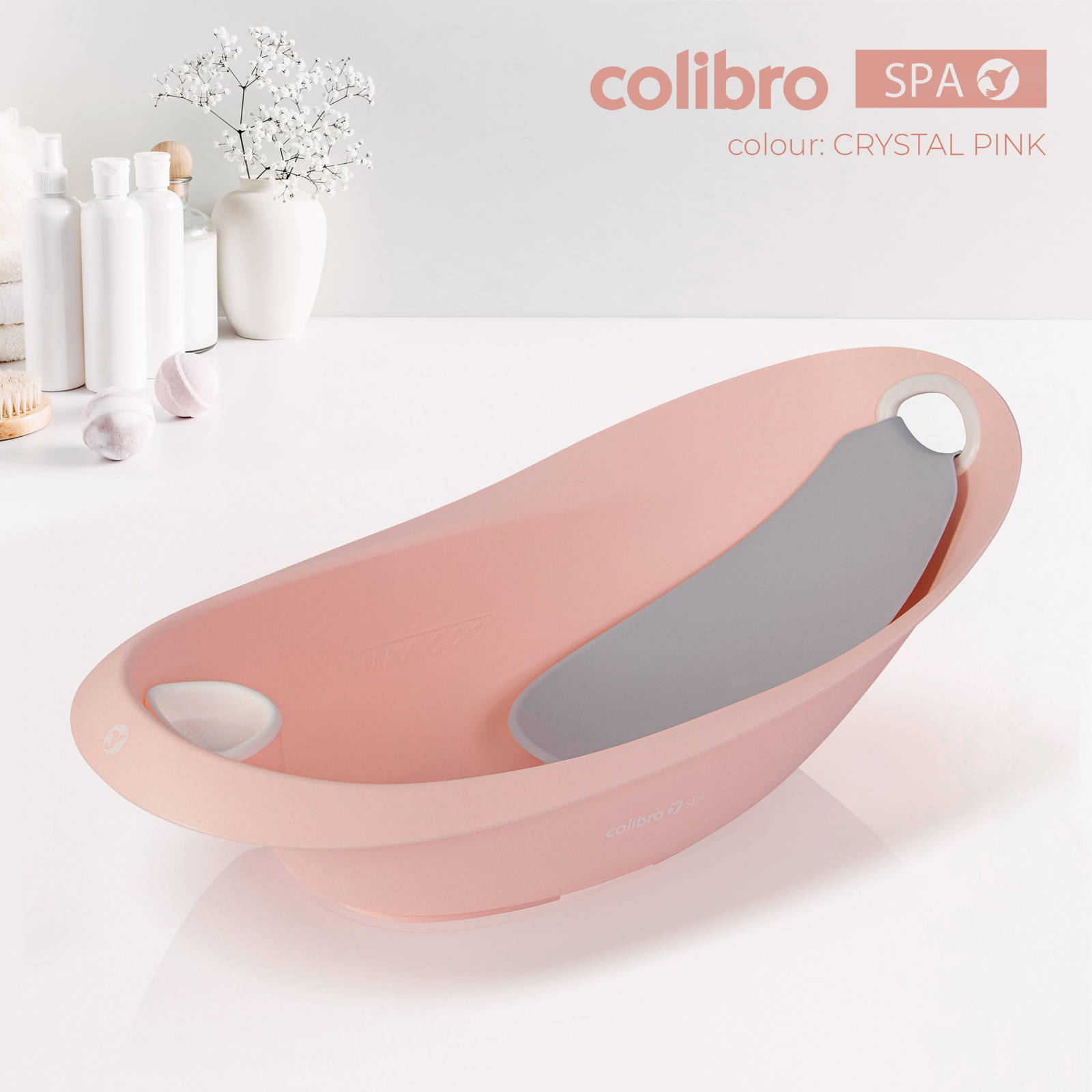 Różowa wanienka dla niemowląt Colibro Spa w kolorze Crystal Pink z szarą wkładką kąpielową.
