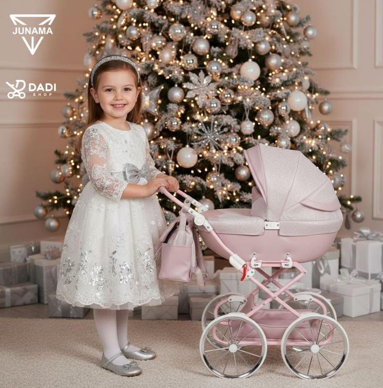Pink Junama Dolce Mini doll stroller surrounded by Christmas decorations — the perfect holiday gift for a little girl.