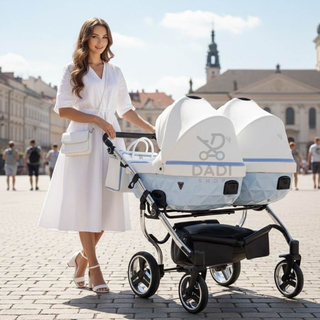 Kobieta w białej sukience z niebieskim wózkiem bliźniaczym Junama Candy Duo V2 na słonecznym placu.