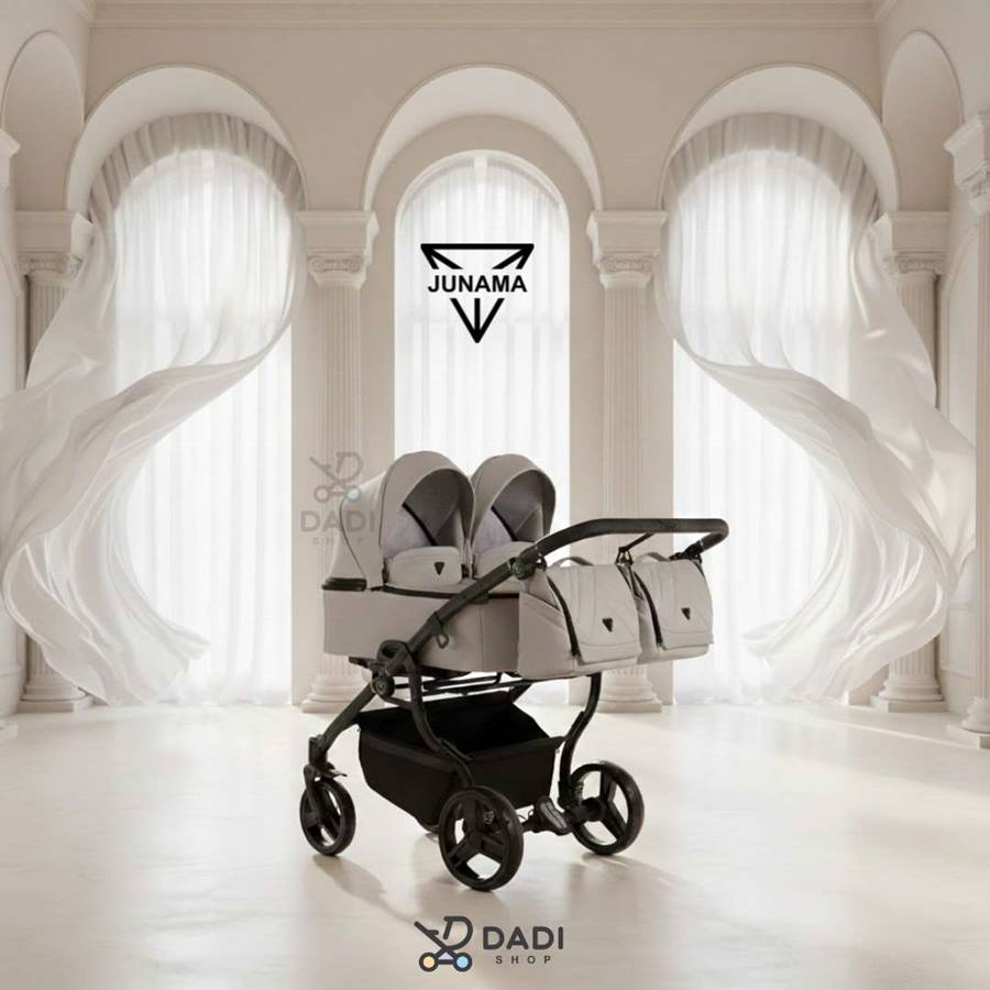 Junama Duo V3 Eco beige twin stroller with side-by-side seats in a minimalist interior.