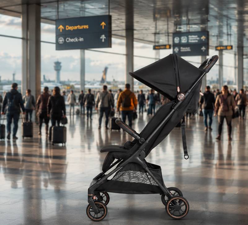 Junama Aviator Black travel stroller at the airport terminal