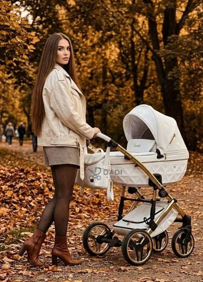 A woman walking in an autumn park with a white Junama Candy Premium 02 White bassinet stroller on a gold frame