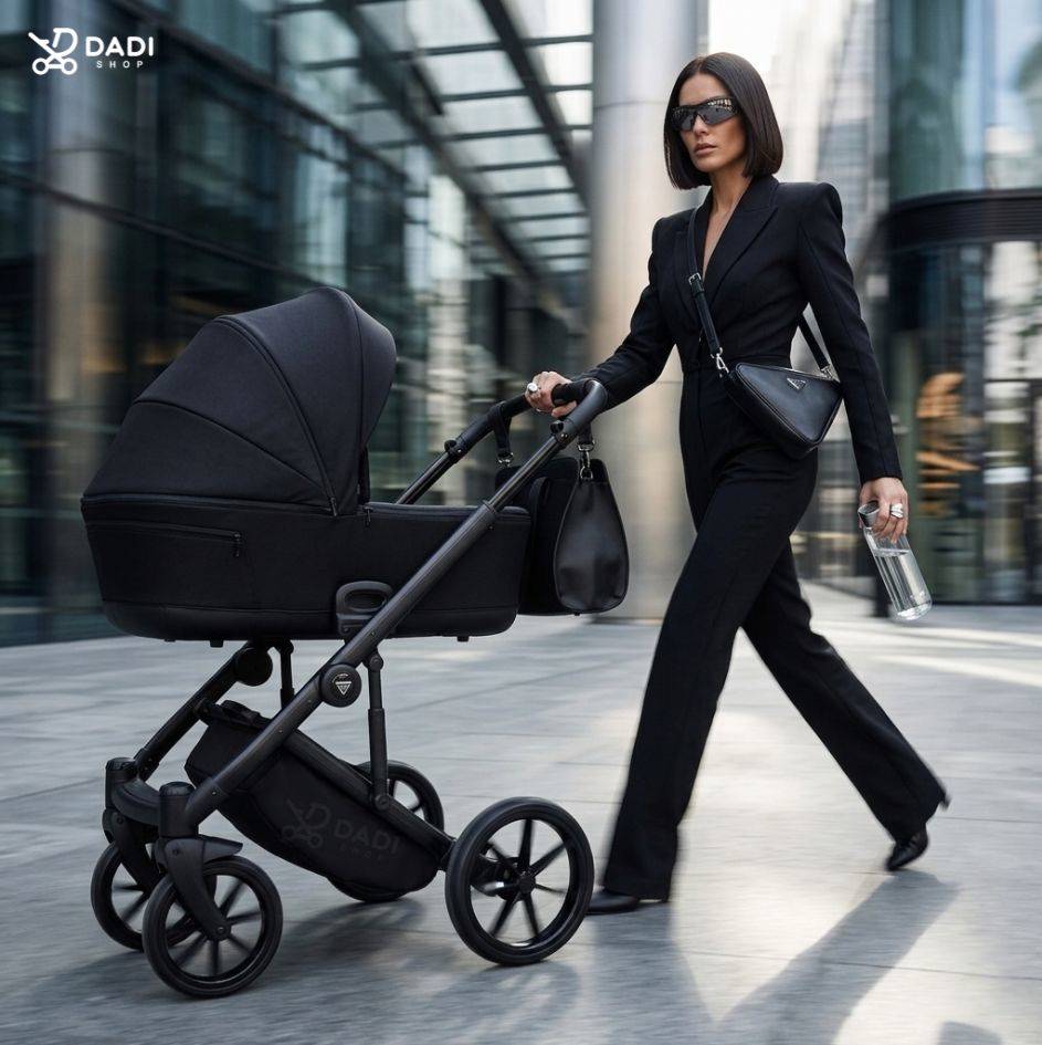 Stylish woman in a black pantsuit pushing a luxury black Junama Elegante baby stroller in a modern city setting