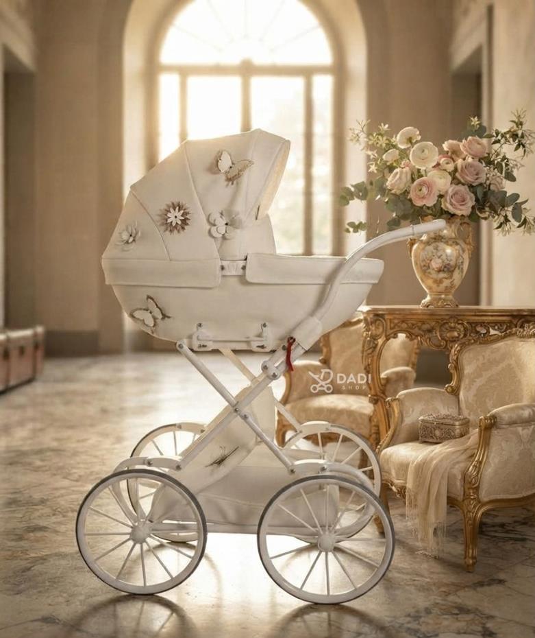 Classic white vintage-style toy baby carriage by Junama Mini Fleur featuring butterfly details in a bright room