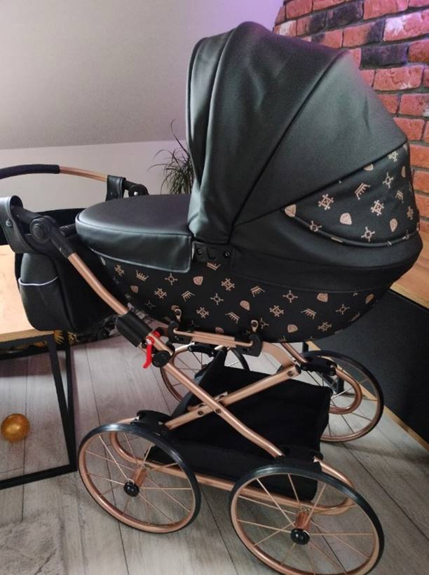 Czarny wózek dla lalek Tako Imperial Mini Classic z dużymi retro kołami – zdjęcie klienta pokazujące realistyczny wygląd i elegancki design podczas zabawy.