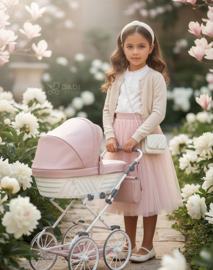 Babies dolls pram Kunert Rossie Pink – girl enjoying outdoor play, stylish and functional toy.